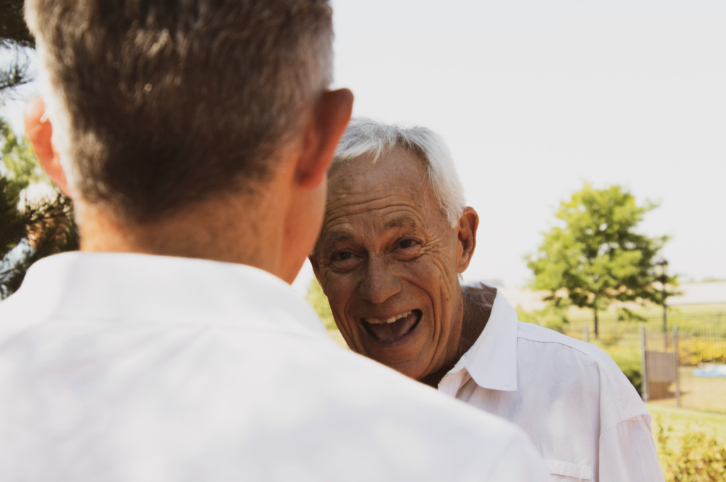 Happy elderly men socialising at the retirement village