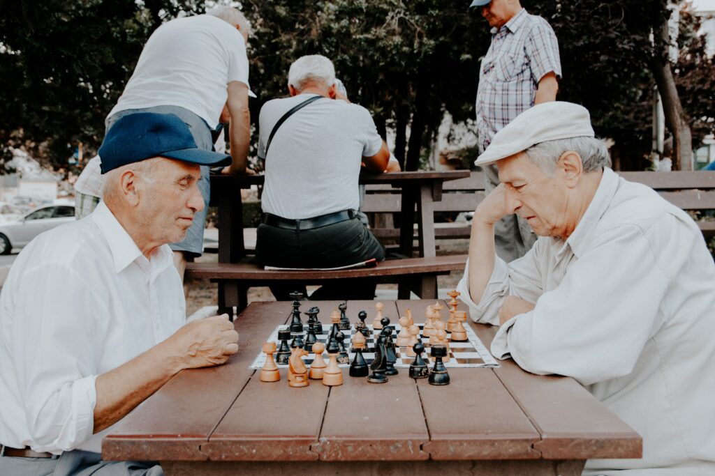 old men playing chess at monte vista